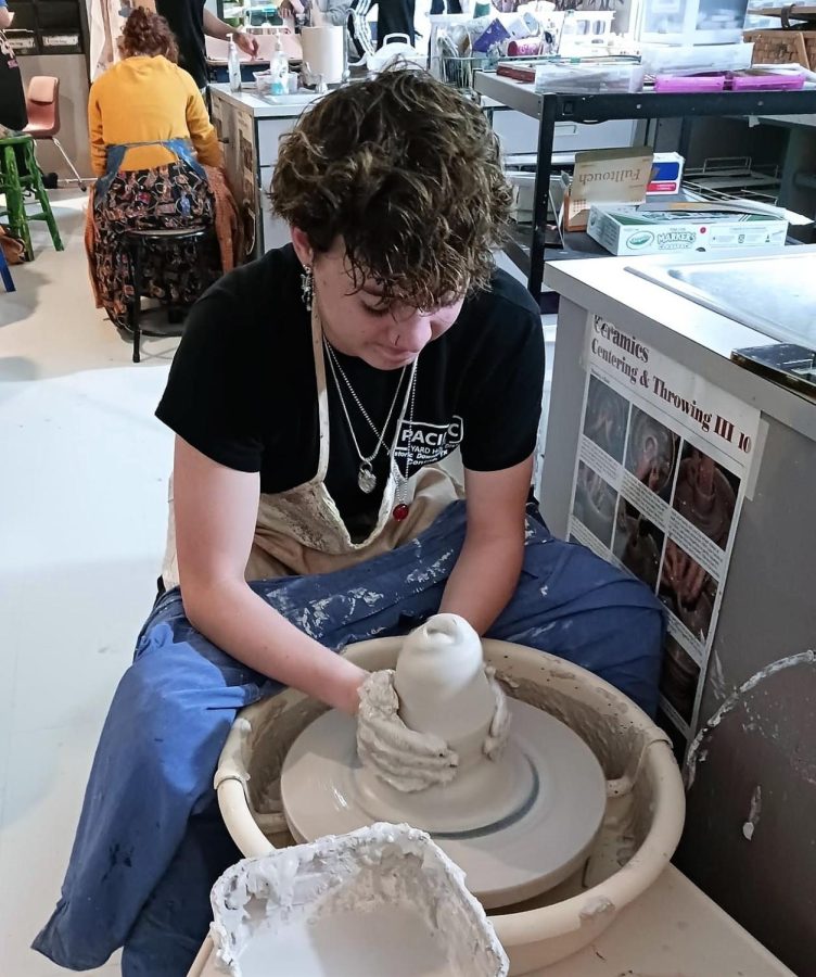 TURNING CLAY INTO ART. In the ceramics class, senior Tori Pierce turns a piece of pottery on the wheel. Advanced art classes focus on ceramics, drawing and painting. 