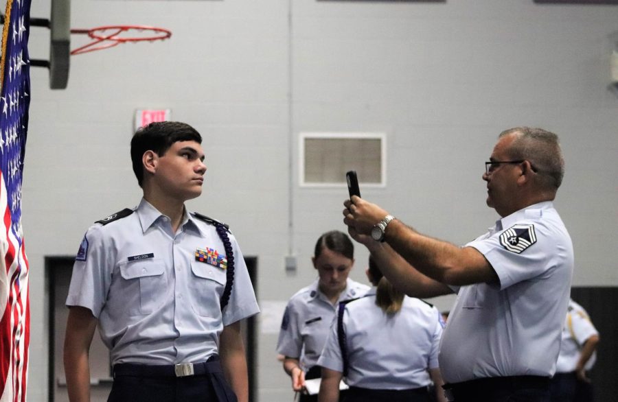INSPECTION READY. Leading by example, senior Jacob Sheldon stands at attention as Sgt. Chris Bell takes a photo. AFJROTC meets once a week for uniform inspection. photo by John Picklesimer.