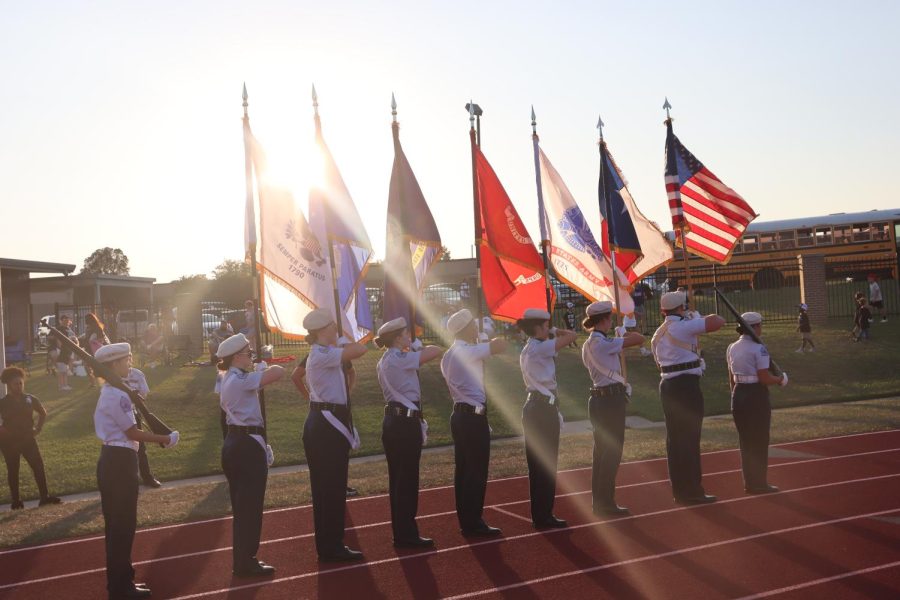LAND OF THE FREE. Preparing to present the flags at the beginning of the game against Grand Oaks, members of the AFJROTC Color Guard line up. The organization presents the flags at the start of every home game. photo by Brody McNew
