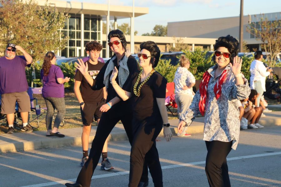 VIVA LA VEGAS. Volleyball coaches Megan Storms, Kaley Evans and Bailey Wilson  participate in the parade getting groovy while dressed like Elvis Presley. They walked with the volleyball team in the Vegas themed parade. 