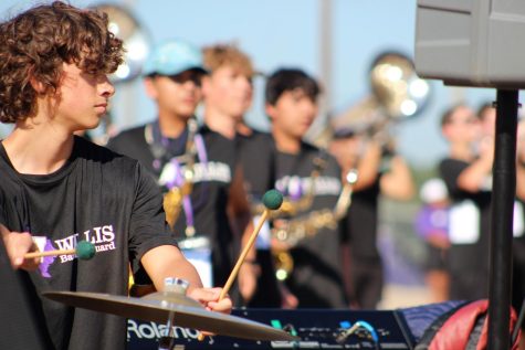 INTO THE BLUE. Part of the front ensemble, sophomore Noah Johnston plays his part during the 1st place performance. 