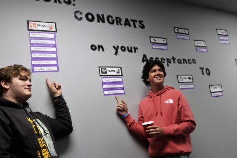 THATS ME. Pointing out their names on the college acceptance wall, seniors Jonathan Dozier and Colin Utecht enjoy their coffee at the Coffee with Counselors event. 