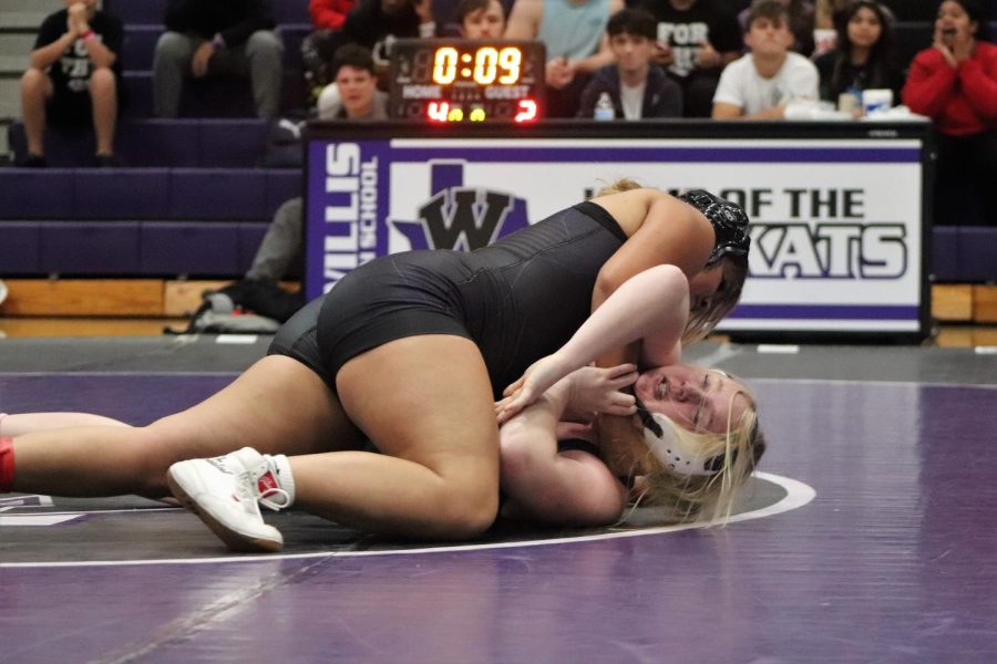 TAKING+CONTROL.+Dominating+her+opponent%2C+junior+Melanie+Garcia+wrestles+in+the+dual+against+Kingwood+Park.+The+team+has+been+busy+competing+once+or+twice+a+week+to+prepare+for+district+competition.+