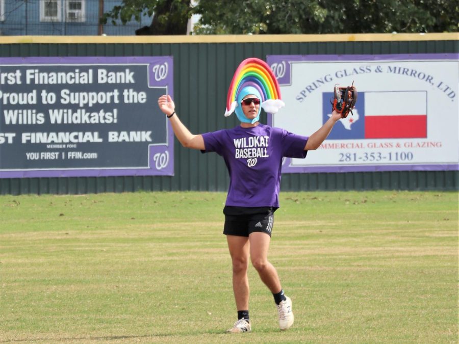 RAINBOW IN THE OUTFIELD. Opting for just a crazy hat rather than an entire costume, junior Mason Bearden plays the outfield in the scrimmage. 