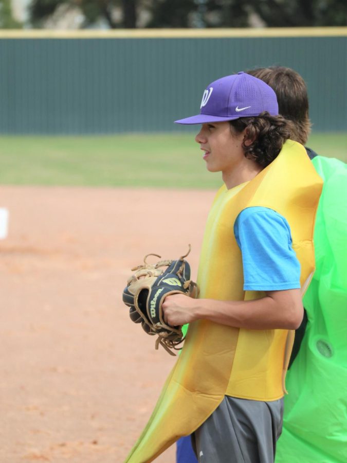 THIS IS BANANAS. Warming up for the scrimmage freshman Justin Zakos works around his costume. The teams were mixed for the scrimmage with both teams having varsity, jv and sophomore team members. 