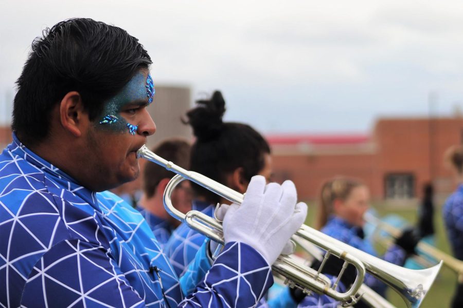 LOOKING SHARP. With his face decorated for competition, senior Tony Silverio prepares to lead the band as drum major and also play as a featured trumpet player. 