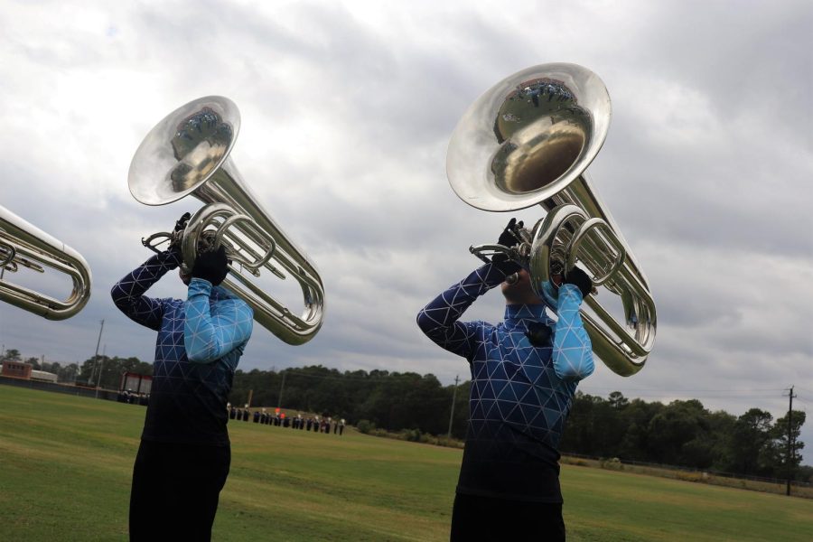 INTO THE BLUE. With a blue sky behind them, band members warm up for their area performance. 