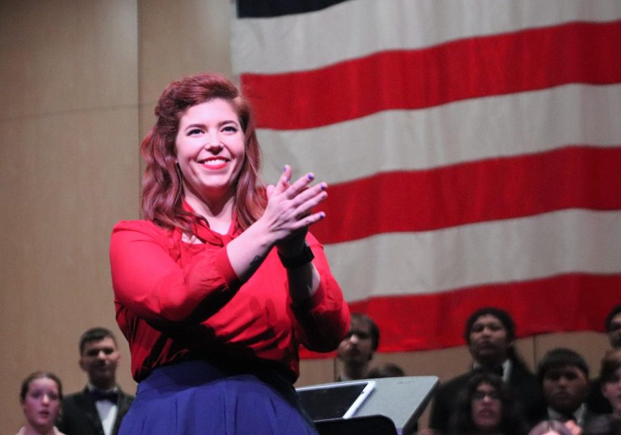 WECLOME. Introducing the choir to the audience, choir director Laurelyn Korfage smiles at the Veterans Day concert. This is the first year for her to be head choir director. 