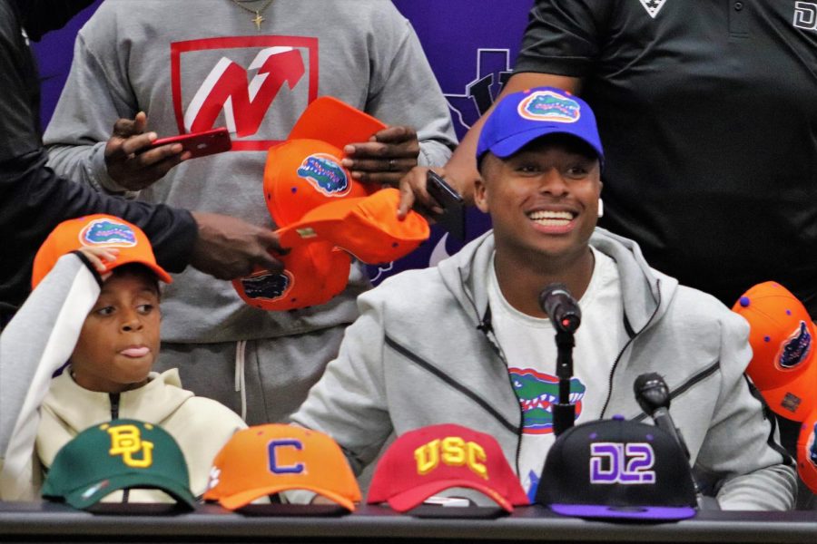 GO GATORS. With his friends, family and coaches there to watch, junior DJ Lagway picks up the Florida hat, signifying his commitment to the Gators. Lagway chose the University of Florida over Baylor, Clemson, USC, and Texas A&M.
