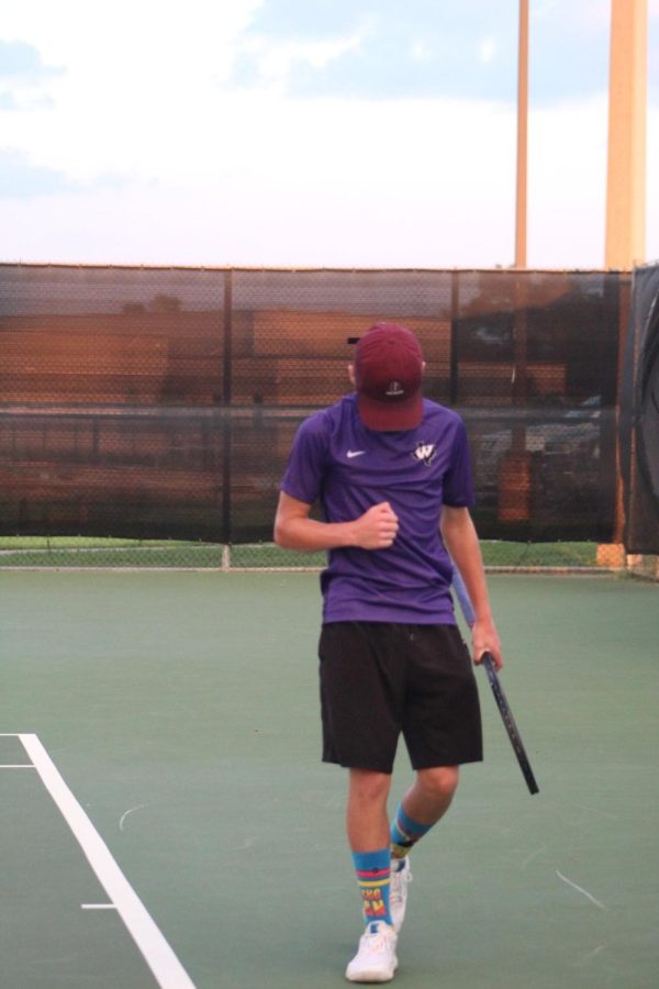GAME, SET, MATCH. Playing against a district opponent, freshman Bryce Bickley celebrates after winning a point. Bickley and the rest of the team will travel to Humble on Friday and Saturday, January 27-28 to compete in a tournament against many different schools.