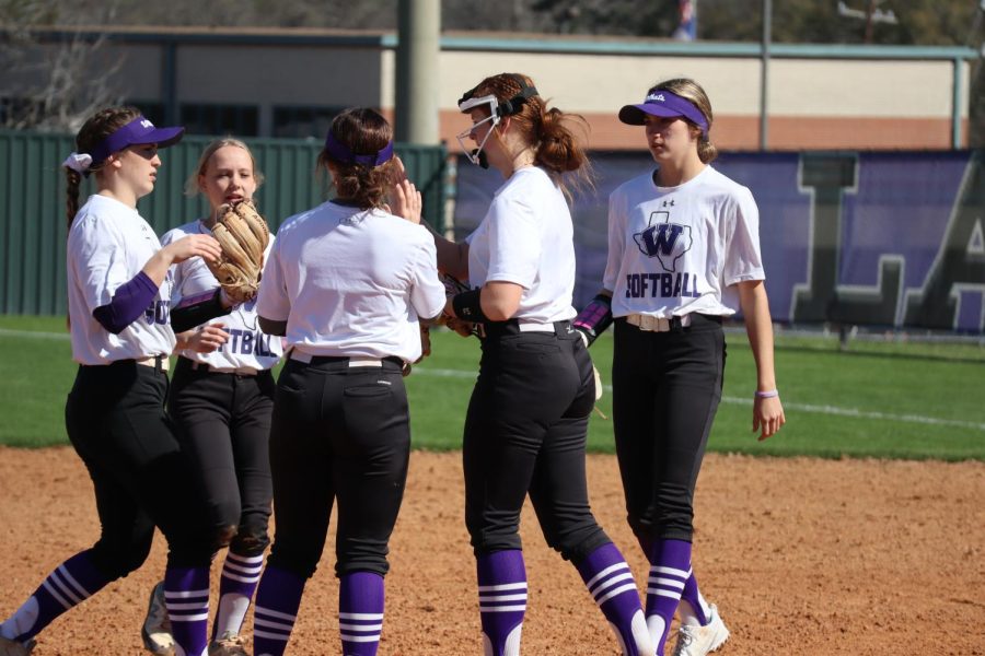 BREAKING THE TENSION. Seniors Lainey Niederhofer, Jolie Boyd, Hannah Hartman and Lindey Hues talk to pitcher Kynlei Chapman during the scrimmage against Livingston. 