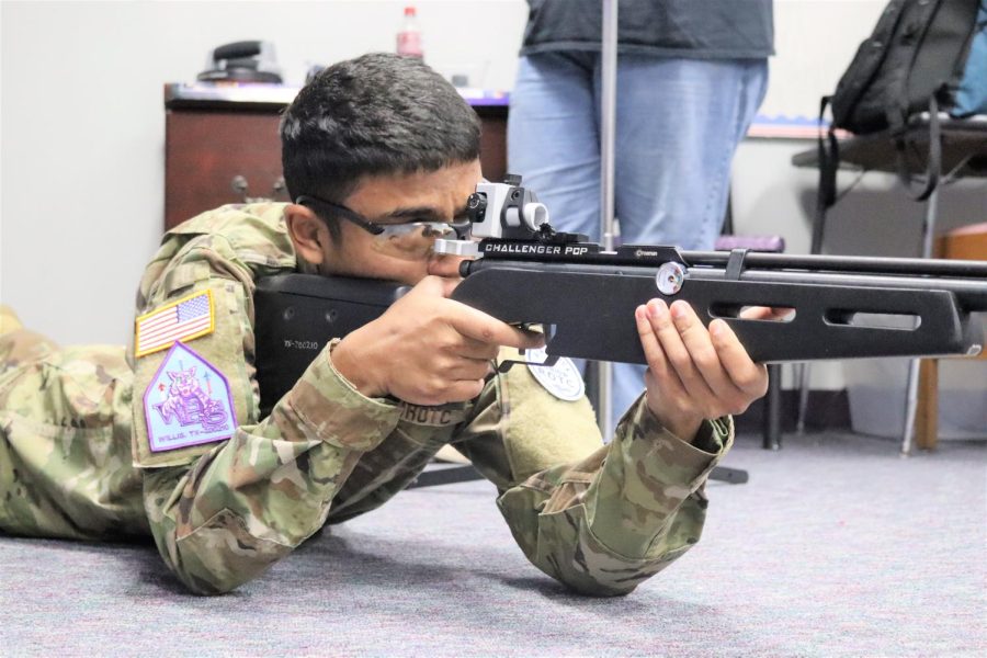 COCK, LOAD, SHOOT. Senior Joshua Ramoutar shoots his rifle during Marksmanship practice. While competing shooters only have 10 minutes to shoot 10 rounds in the prone position. 
