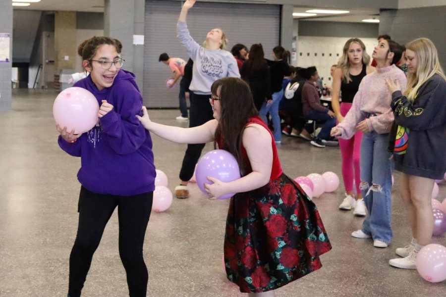FUN+AND+GAMES.+At+the+Valentines+Day+party+sophomore+Samantha+Kramer+and+senior+Lizzie+Moore+dance+and+play+with+balloons.+StuCo+plans+a+party+each+year+celebrating+Valentines+Day+with+students+of+Champions+Academy.+