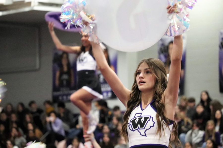 PURPLE AND WHITE. Performing the UIL routine Natalie Gooden holds her sign and poms. The competition squad show off the routine they performed at state. 