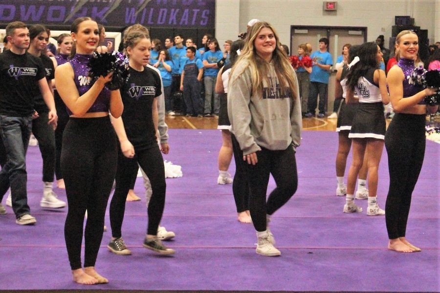 ON THE MAT. Walking with the wrestling team, senior Janice Talley lead the group in the spring pep rally. 