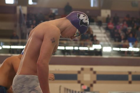GAME TIME. Before he swims the 100-yard butterfly, freshman Aaron Barker takes a deep breath before the officials start the race. Barker, alongside three of his teammates, helped reset the school record for the 200-yard freestyle relay at this years regional meet.