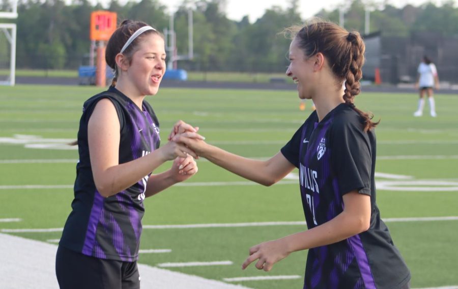sophomores Summer Clark and Presley Wood share a special handshake as the team is announced. The 3-2 play-off victory resulted in a bi-district title for the team. 