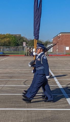COLOR GUARD HALT. Junior Amaya De La Rosa is performing a Color Guard routine with her teammates.  The Color Guard team has an implied amount of respect because they make the most public appearances by carrying flags.