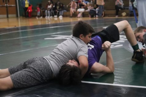 SQUEEZE! Hank and Clint from Brabham Middle school compete in a dual at Huntsville High School. The two students learned how to wrestle two weeks before the competition.