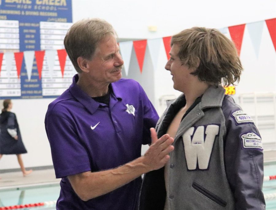 On senior night for the swim and dive team, Coach Dana Fossmo congratulates senior Peyton Sewell.  After coaching swim, cross country and track for decades as a Wildkat, Fossmo is retiring. 