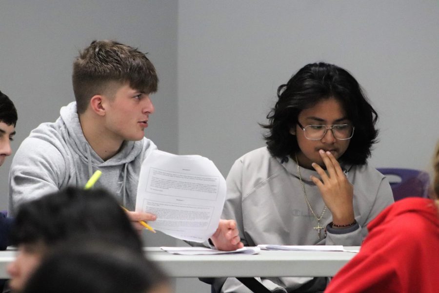 WORDS OF EXPERIENCE. During a Writer;s Workshop junior Jace Yarborough helps sophomore Cesar Barrera with mastering a DBQ. The workshop was held during Wildkat Way for AP World History students who wanted an extra boost on their writing skills before the test. 