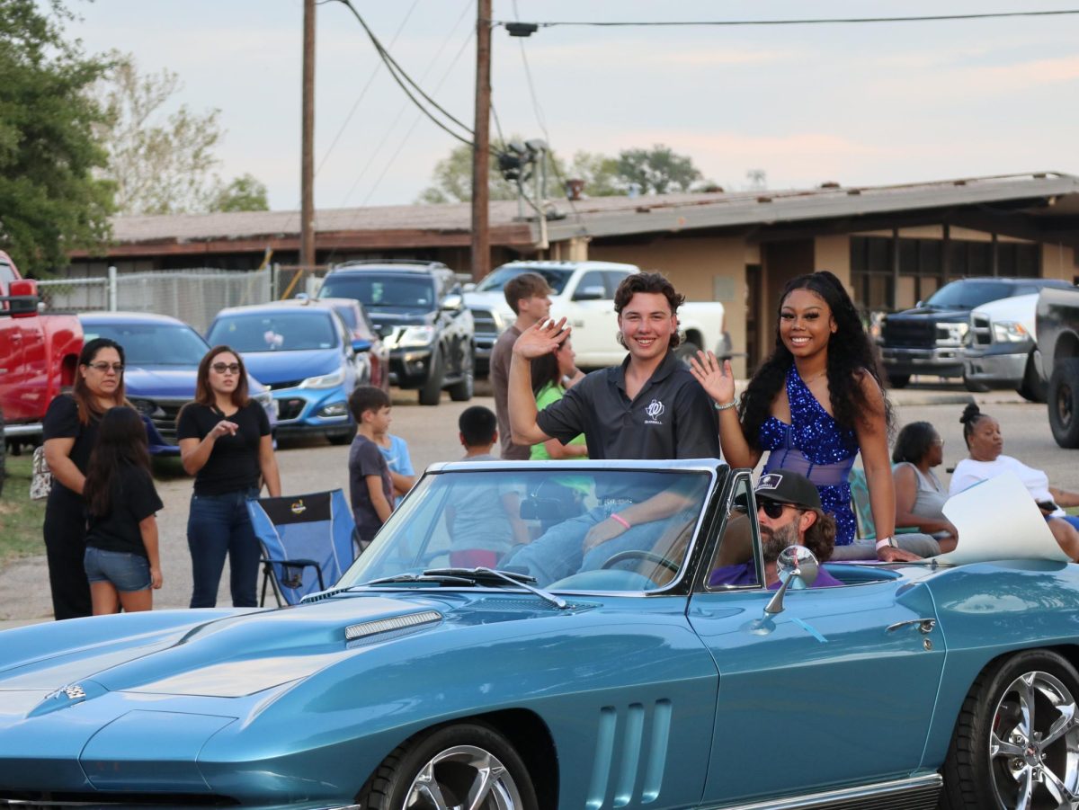 CLASSIC WILDKAT SPIRIT. Homecoming court members seniors Essence Traylor and Austin Gaskins ride in a classic car for the parade.