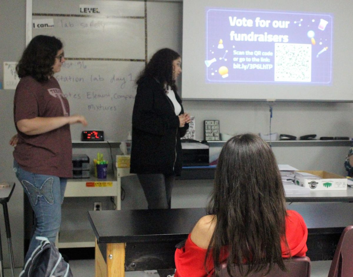 FUNDRAISER SEASON. Morgan Thomas and Jasmyna Joyner talk to the members about the importance of the fundraisers. Every year the science club hosts fundraisers for their activities.