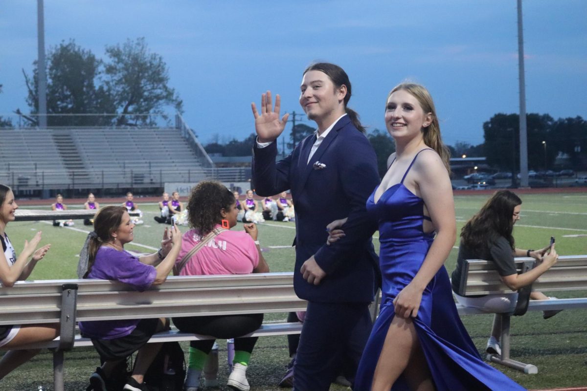 BAND BESTIES.  Seniors Blaise rivero, Lilly Galarneau walk as band belle and beau during Fire Up the Kats. 