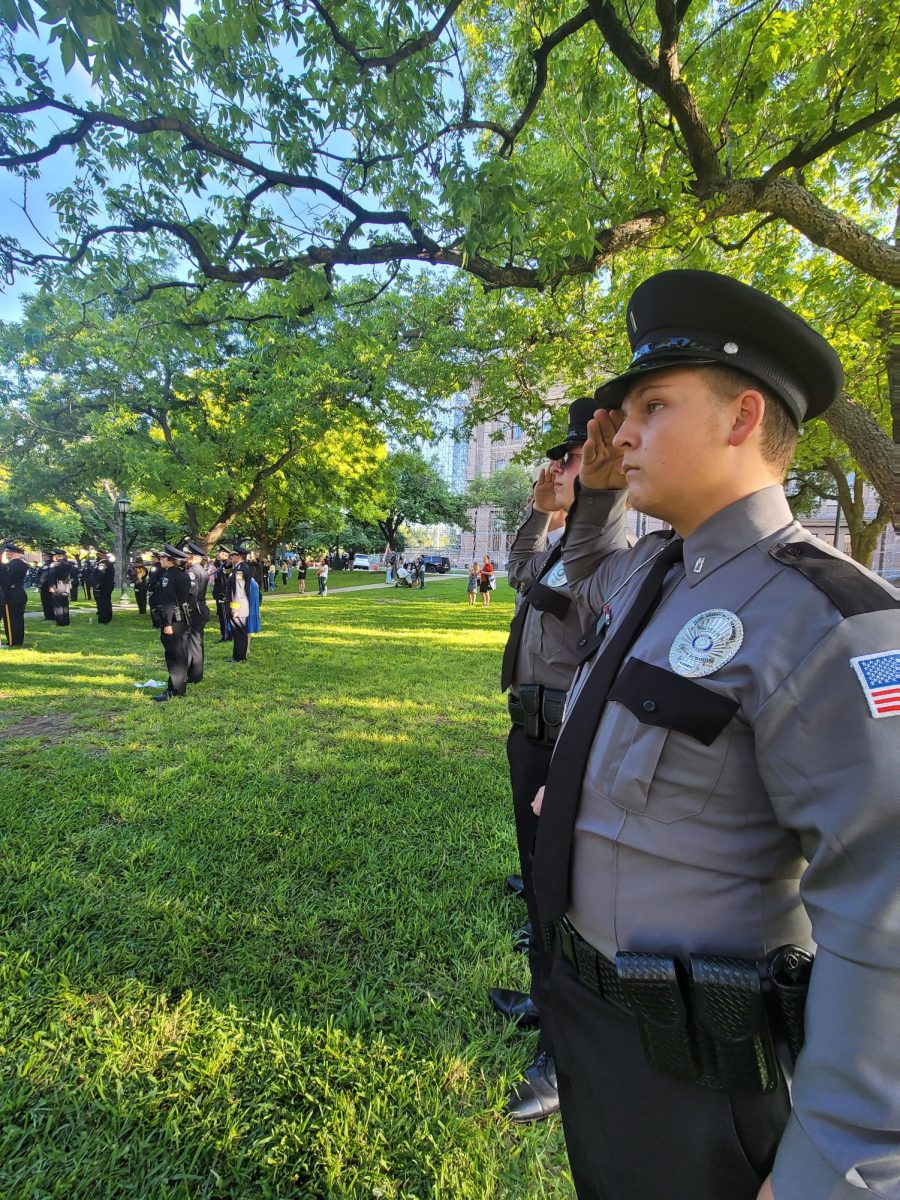 MEMORIAL SALUTE. Saluting in the distance, senior Chase Wiederhold pays his respects at the Texas Peace Officers Annual Memorial.