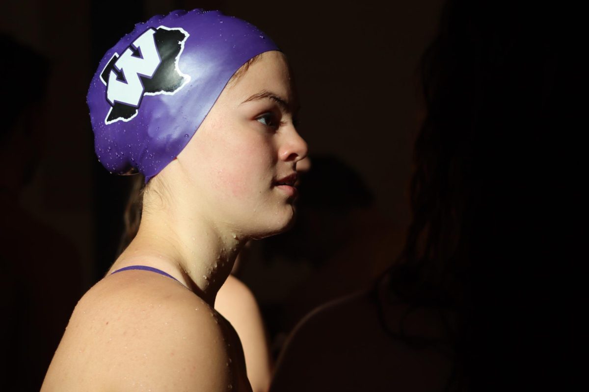 ABOUT+TO+DIVE+IN.+Minutes+before+starting+a+race%2C+freshman+Claire+Mayronne%2C+prepares+to+begin+her+event.+Claire+was+able+to+win+1st+in+both+the+200+freestyle+and+the+100+back+and+placed+3rd+in+the+50+freestyle.+