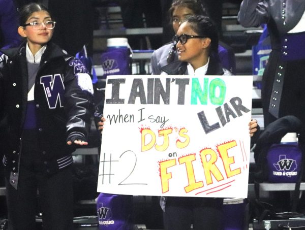 ONLY THE TRUTH. Showing spirit from the band section of the stands, junior Zisel Braza holds a sign of support during the Aldine Nimitz game. 