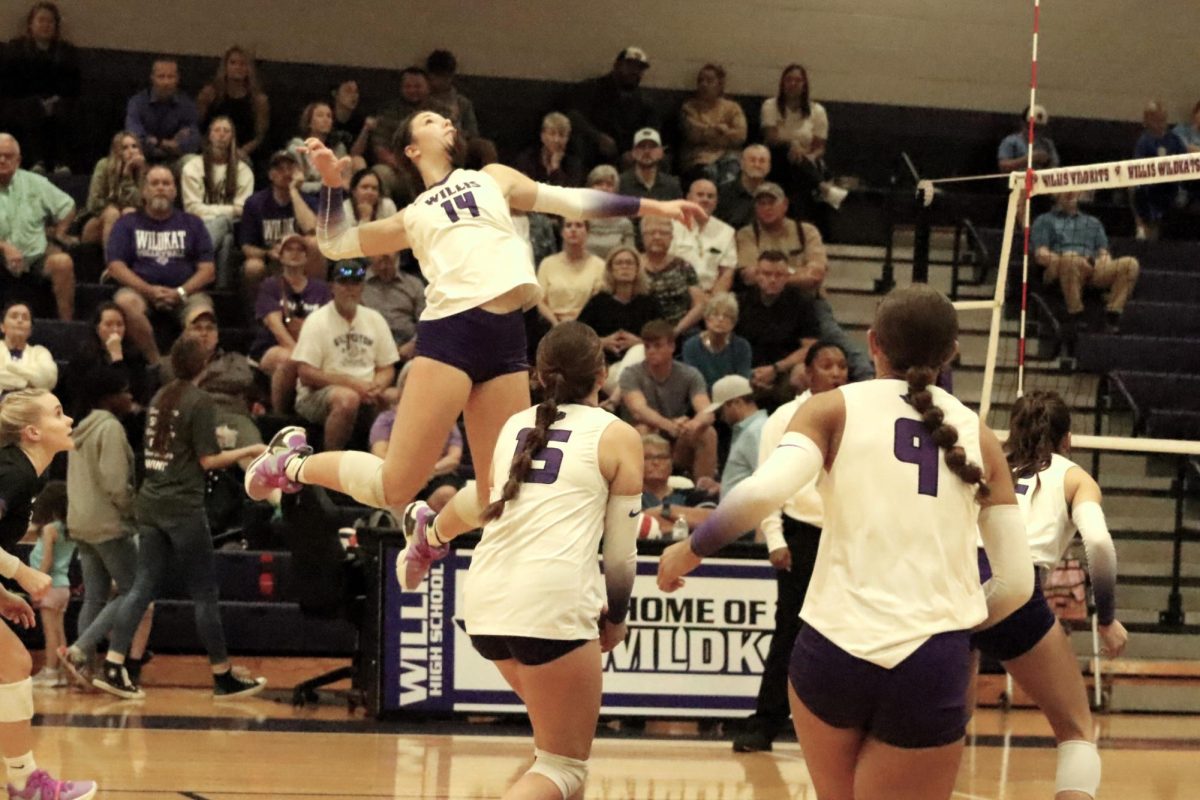 FLYING HIGH. Junior Carly Paugh rises up to hit the ball as hard as possible to gain a point for her team. The volleyball team was able to accomplish big wins this season with many players being able to win various awards. 
