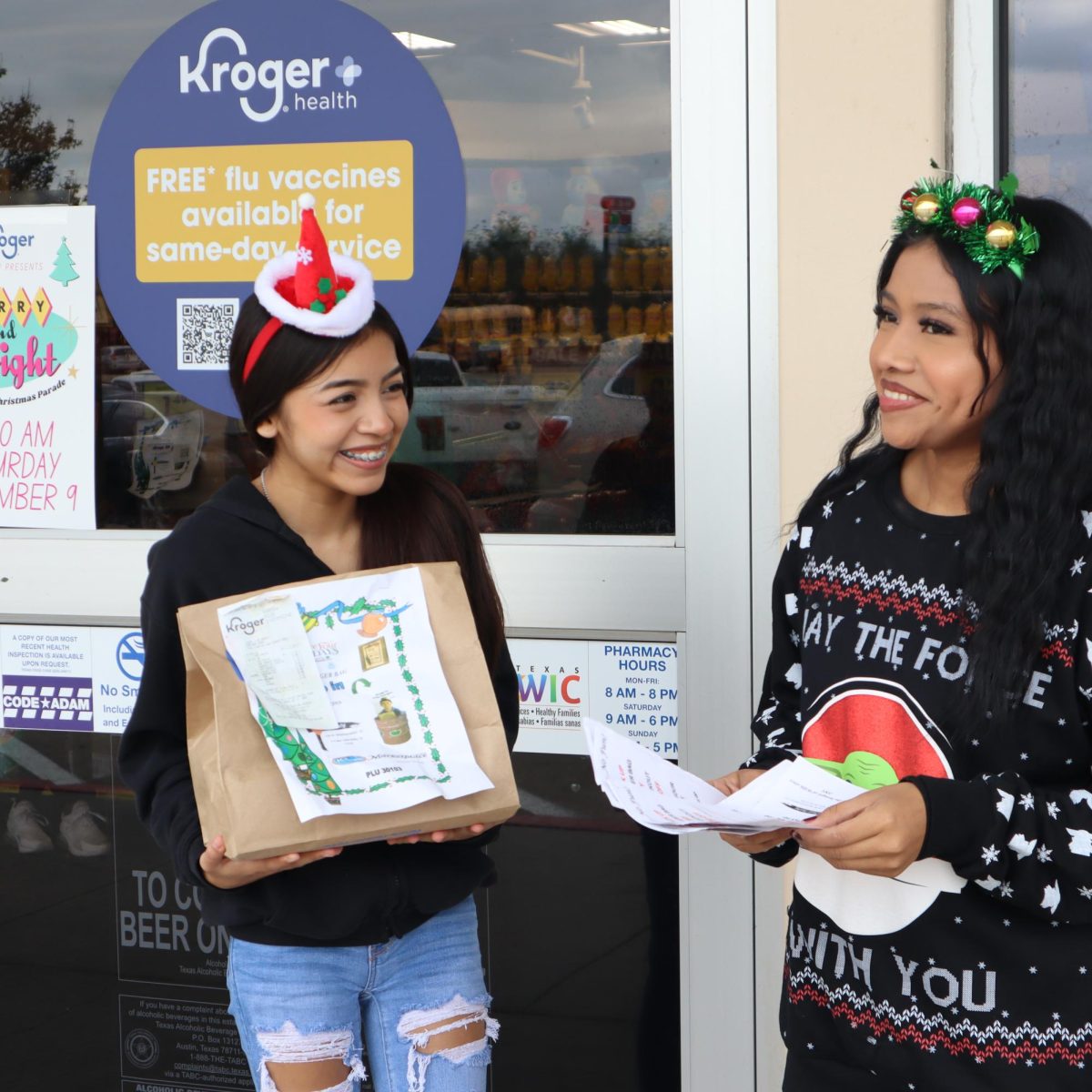GIVING BACK. Wildkat Media students Diana Negrete and Sujeidy Negrete volunteer to help raise money for the local food pantry.