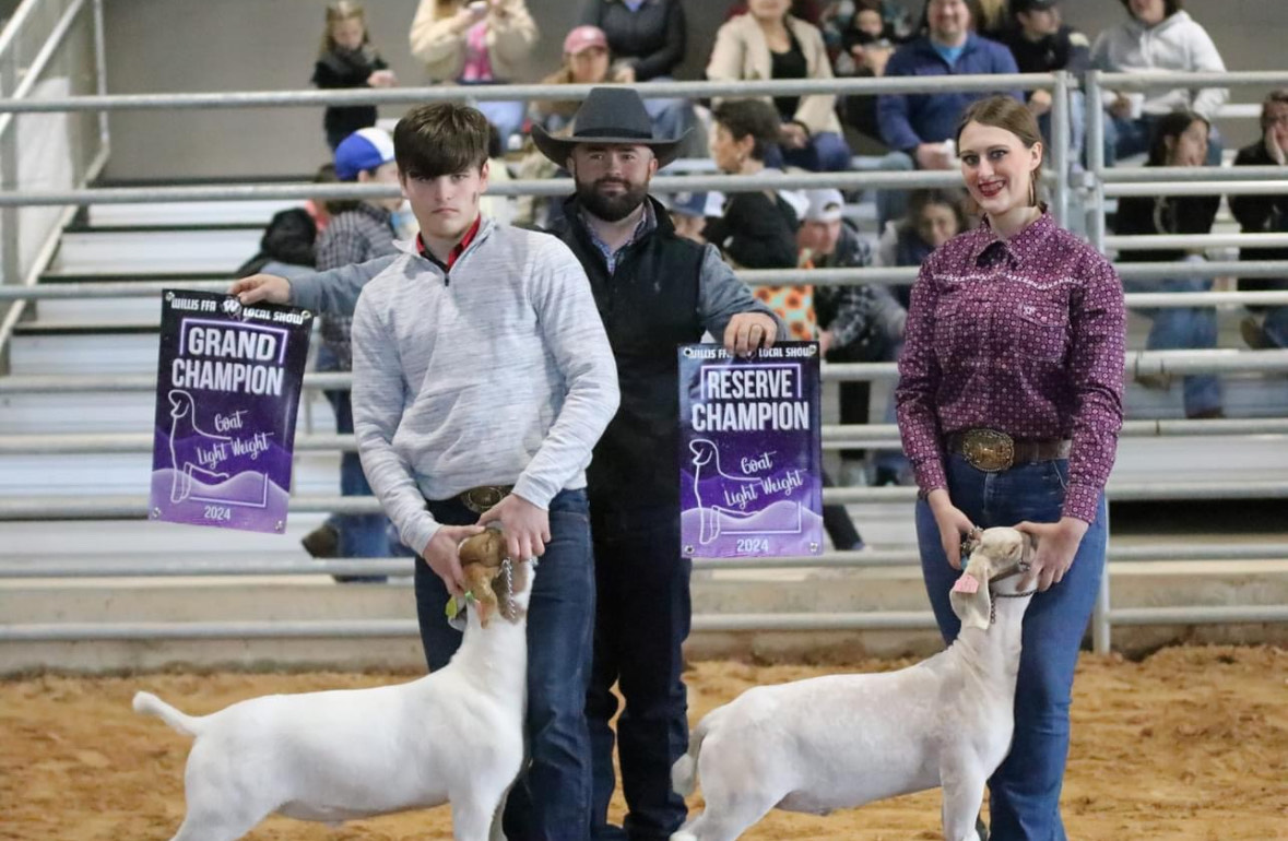 GIFTED GOATS. Winning Grand Champion Goat, sophomore Jackson Dutton, and winning reserve Champion Goat, junior Meaghan Evans, show off their victorious animals. The Willis local show was an opportunity to practice FFA students ability of showmanship and the pride they have in their animals.