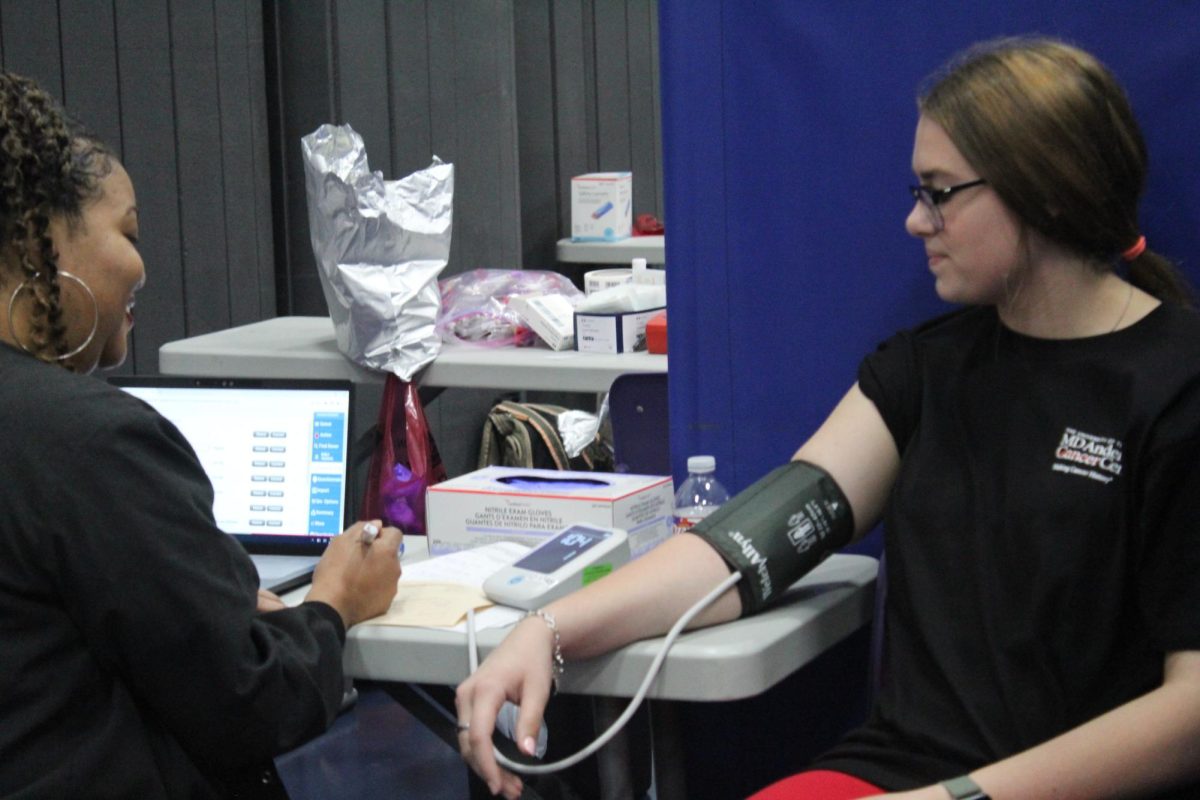 TO SAVE THREE LIVES. In the fall blood drive, senior Emily Vaughn begins the donation process.
