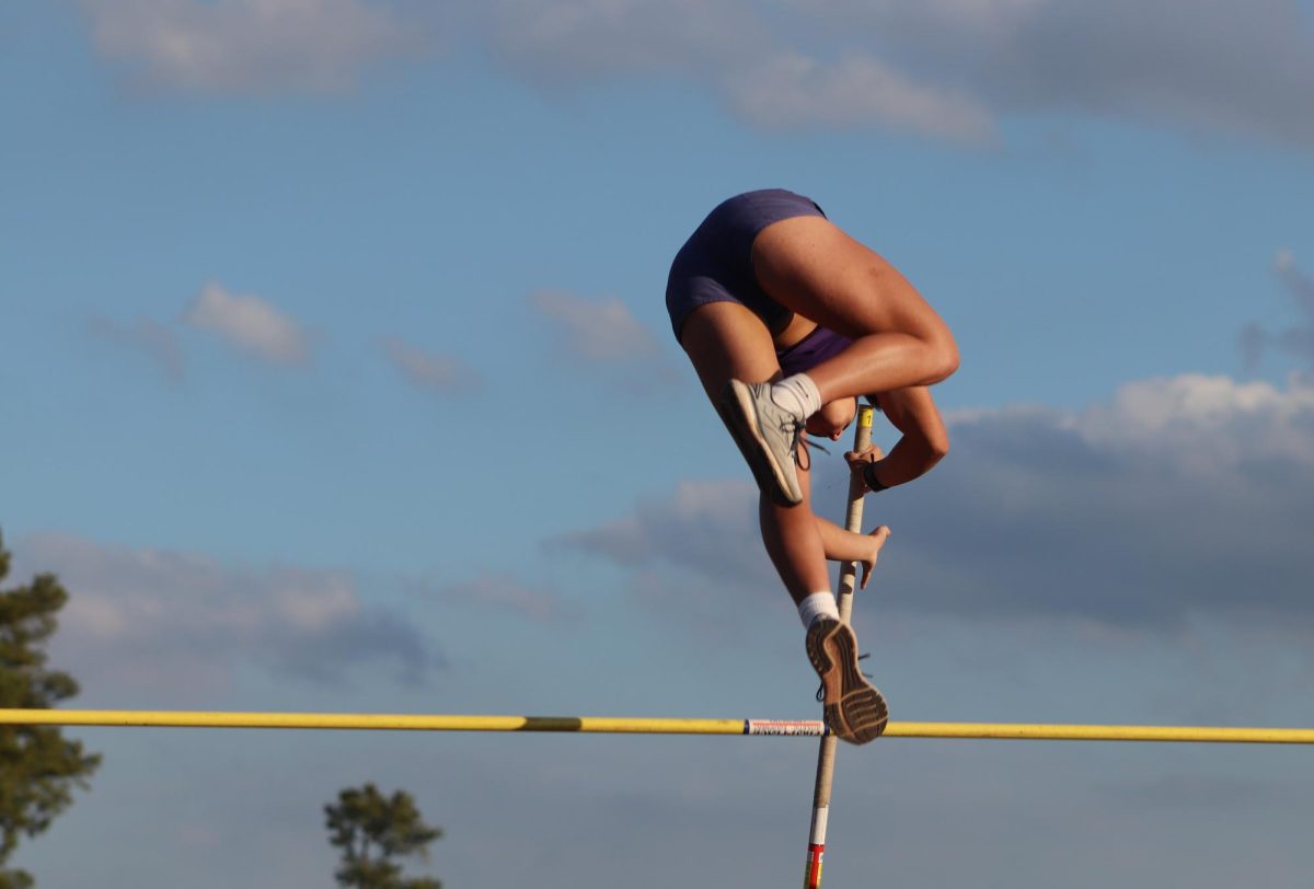 FLYING HIGH. At the mock track meet held on Thursday, junior Kaeley Uhlig flies over the bar during the pole vault competition. photo by Danica Sundquist