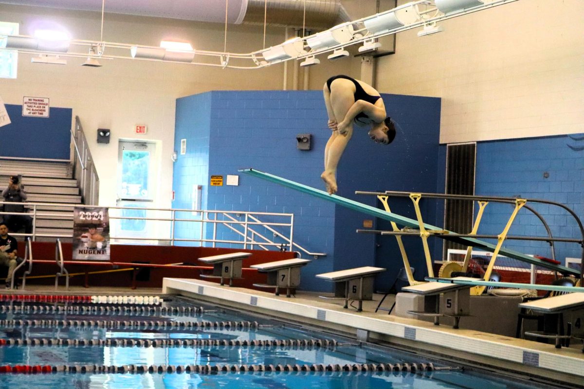 MAKING+A+SPLASH.+At+a+competition+during+the+regular+season%2C+senior+Kelsey+Weddington+dives+into+the+pool.+Weddington+placed+11th+at+the+state+meet+and+will+dive+for+Tulane+University+in+the+fall.+