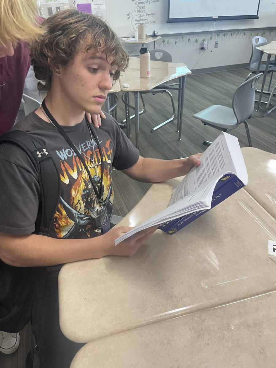 Eyes on the future. Senior Trenton Lightfoot reads his textbook to prepare to get his real estate license and create a strong career. 