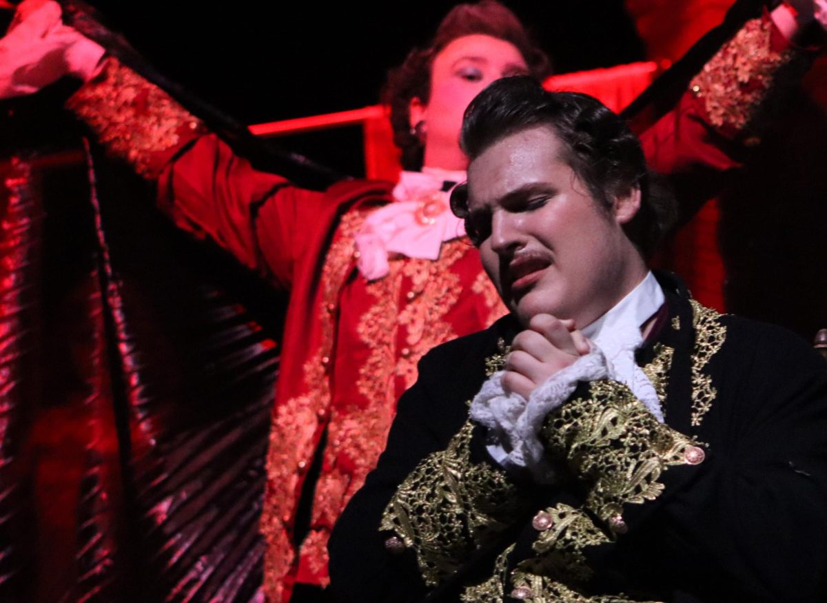 ROCK ME AMADEUS. In a scene from the One Act Plays public performance, Antonio Salieri, played by senior Aiden Hamilton, prays as death, played by senior Marcus Shumake darkens the stage. At zone competition on Thursday, Hamilton was named Best Actor by the judges. Also named best actor was Breanna Keelan who played Constanze Mozart. photo by Ava Hardin