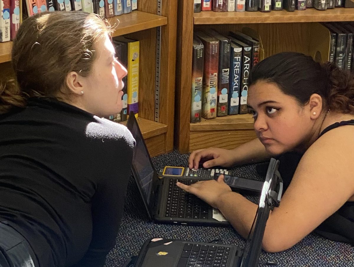 PROSE PALS. After round one of district competition seniors Breanna Keelan and Gracie Saucedo work on homework at Caney Creek High School. Both seniors placed at their first time competing in district. 