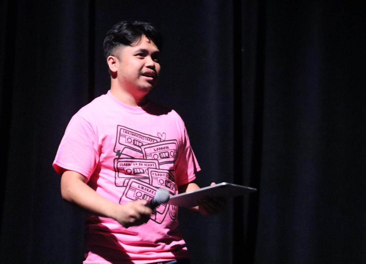 END OF THE SEASON. Acting choir director Brandon Ramos addresses the crowd at the spring Pop Show. Ramos led the choir during contest season while director Chelsea Jimenez was on maternity leave.