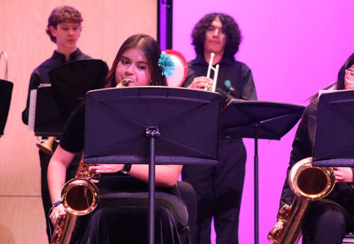 Dulce Silverio playing her saxophone along with all of her band teammates.
