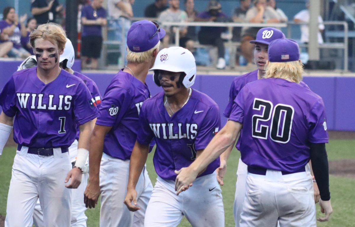 ON THE BOARD. The team celebrates with senior Jaden Menjivar after he scores the first run against Klein Oak in game one of the series. The Kat wons won both games 4-0 in the area championship series. 