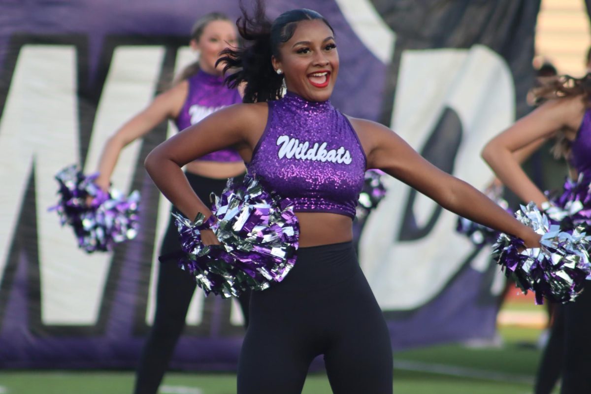 SENIOR SMILES.  While performing on the field experiencing her last ever meet the Kats “emotions were high but it felt very memorable and fun to spend that time with some of my favorite people” senior Andrea Harvey said.