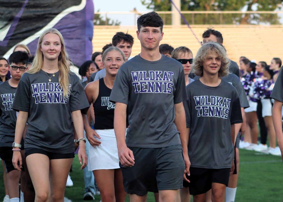 SEEING DOUBLE. As they are announced on the loudspeaker, senior Cade Ford, followed by junior Great Hueher and sophomore Coby Boyd strut out into the field representing the Willis tennis team during Meet the Kats. Ready for their next big hit, the team brings cheer to the stands. “I want to be successful in this year's season and being surrounded by school spirit brings me hope,” Ford said, “It being my last year makes this all the more bittersweet.”