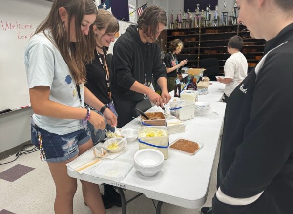 Junior Katya Bargerstock, senior Sapphire Sparka, senior Tripp Henager and senior Kei Laas serve ice cream to fellow choir members.