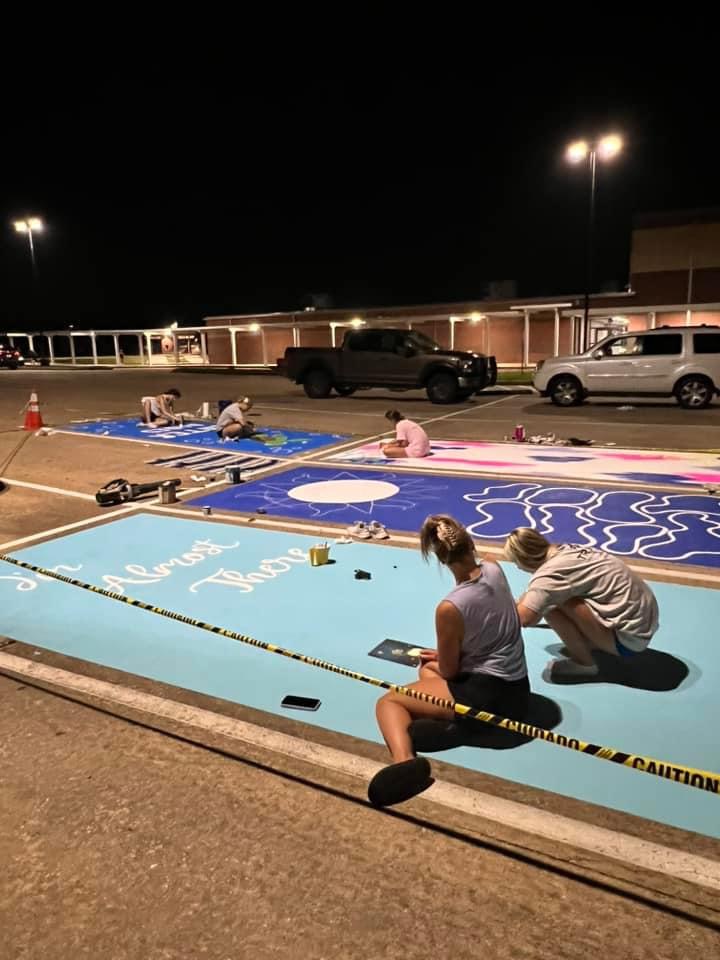 SUMMER NIGHTS Taking advantage ot cooler nights, seniors paint their spots in the summer. To paint their spots, seniors reserved and paid for their spots in May.