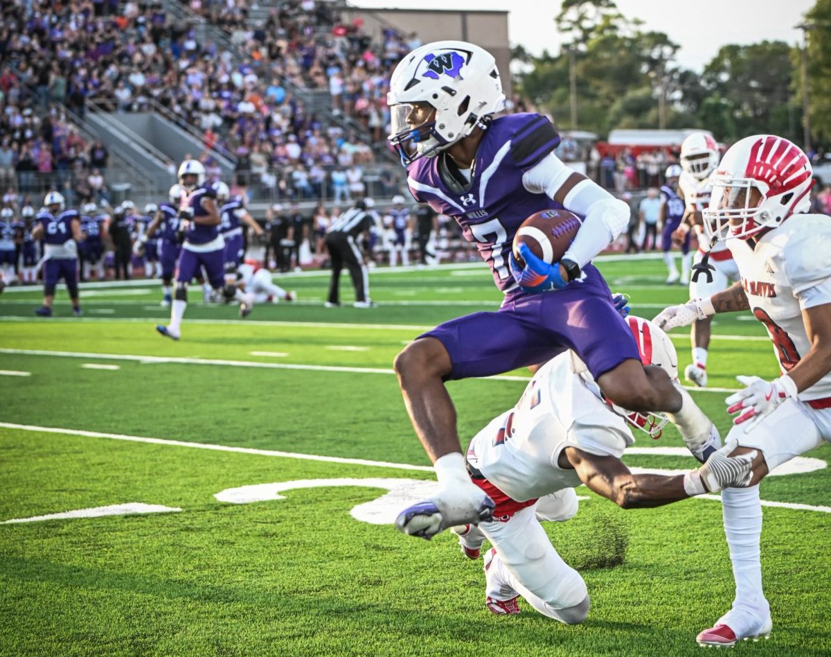 UNSTOPPABLE. Hurdling over defenders, junior Jermaine Bishop lets nothing get in his way of a first down. In the first game of the season Bishop accumulated 117 years and 14 years on kick off return. 