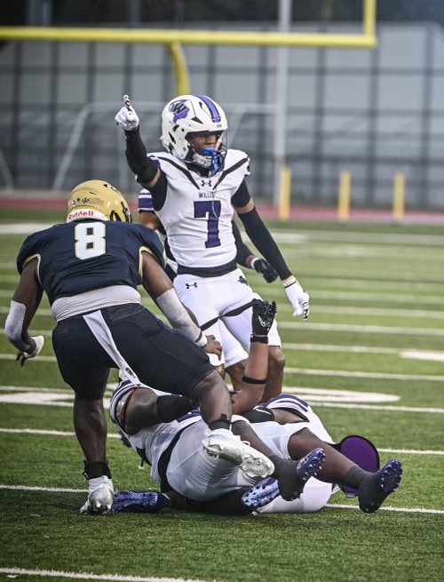 TURNOVER TIME. Sharing with the crowd the results of the play, junior Jermaine Bishop signals Wildkat ball after a turnover against Klein Collins.