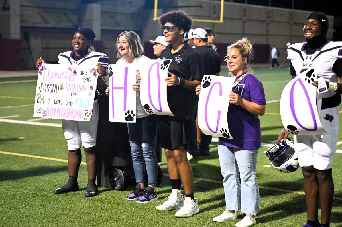 HOCO? During halftime, senior Terri Lawrence asks his girlfriend to homecoming. The individuals who assisted him are instructional coach Lindsay Miller, sophomore Jaden McIntyre, history teacher Amy McGowen and senior Kelan Harris. 